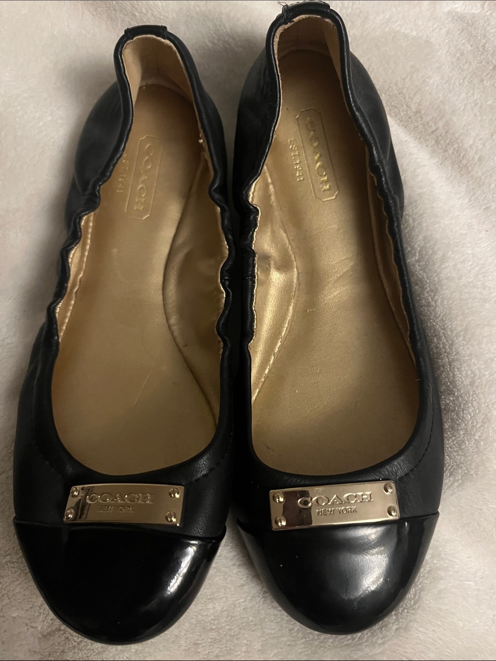 COACH Black Leather Ballet Flats with Gold Plaque Accent